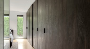 A long line of dark timber coloured cabinetry architecture, building, ceiling, concrete, design, floor, flooring, furniture, hall, hardwood, home, house, interior design, loft, plywood, property, room, space, wall, wood, wood flooring, gray, black