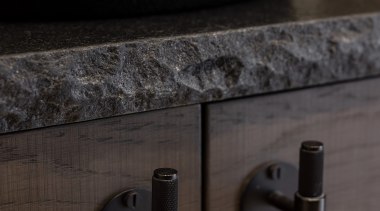 A rock edge stone benchtop adds to the 