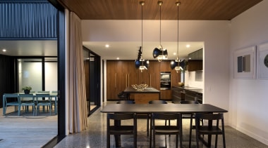 This black and wood kitchen connects with the 