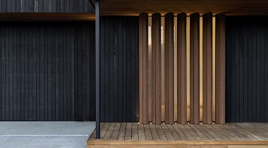 Timber fixed louvres set in front of opaque 