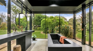 The black concrete custom bath is internally heated. 