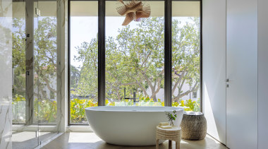 The primary bathroom highlights the freestanding statement tub 