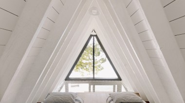 The mezzanine master bedroom slots into the peak 