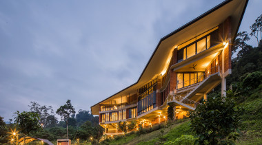 The home grew organically in form as the architecture, building, cloud, cottage, estate, evening, facade, farmhouse, grass, hill station, home, house, landscape, natural landscape, property, real estate, residential area, rural area, sky, tree, teal, brown