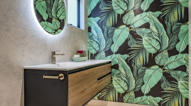 The cantilevered wood vanity complements the dramatic tropical 