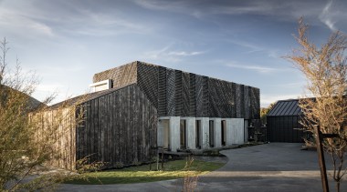 The wooden elements of this home's facade will gray