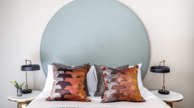 In another guest bedroom, a bespoke headboard is 