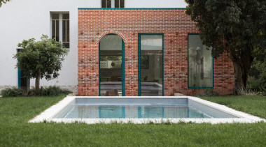 A large brick cube stretches out into the 