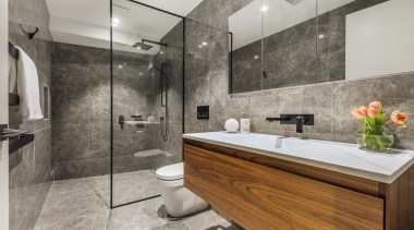 A glass shower stall panel and blanket stone-look 