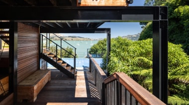 Beneath the terraced outdoor living area. - Through 
