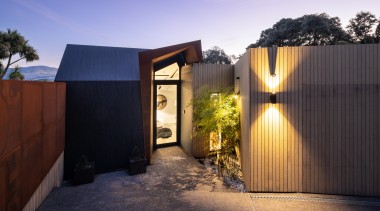 A sculptural Corten steel portal stands in the 