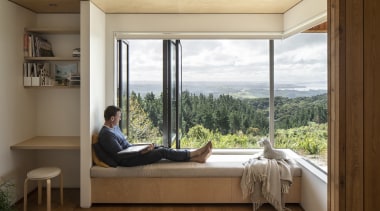 Here bench seating provides storage while bi-fold windows 