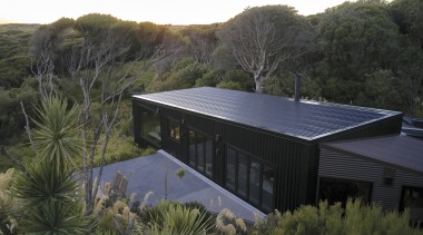 The structure is bedded into the landscape, hunkering 