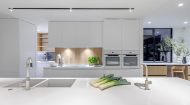 Two sinks and a water dispenser feature on 