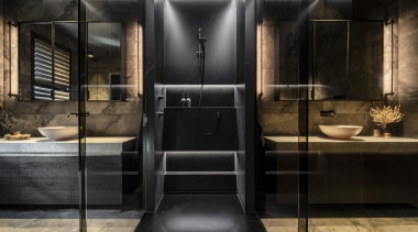 A central shower stall divides two sides of 