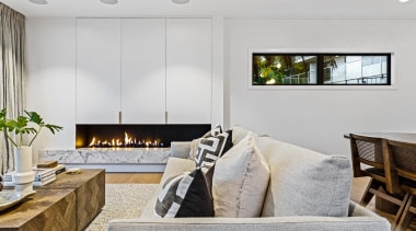 The living room with custom indoor steel-backed fireplace 