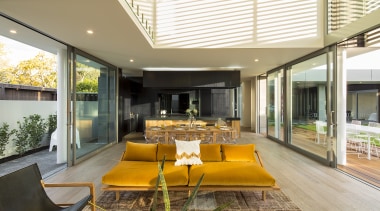 The living area has large opening doors east 