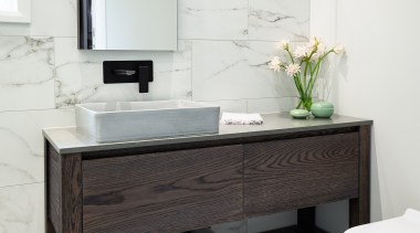 The large, custom-designed vanity includes wide drawers for 