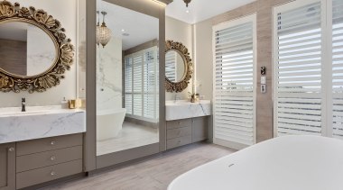 This luxury bathroom by designer Mark Bruce boasts bathroom, bathroom accessory, bathroom cabinet, estate, floor, flooring, home, interior design, room, window, gray