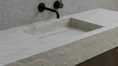 The blackened brass circular mirror sits above a 