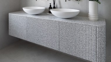 The basins are custom Corian ovals and the 