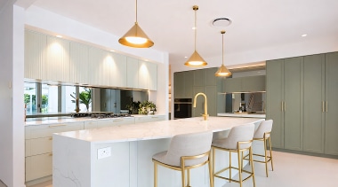Cool white stone benchtops and an integrated white 
