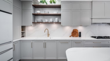 Cornices and panelled cabinetry give the kitchen a 