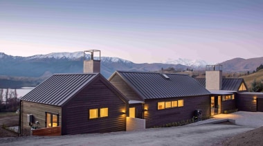 The house is wrapped in black cedar weatherboards 