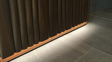 Concealed lighting highlights the wall finish. 