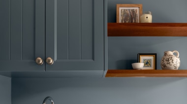 The laundry cabinetry echoes the board look-fronted cabinets 