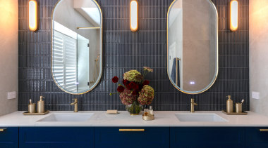 The master ensuite features moody charcoal finger tiles. 