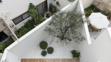 The home includes an outdoor courtyard at the architecture, building, courtyard, floor, grass, home, house, landscape, plant, property, real estate, roof, room, urban design, gray, outdoor living