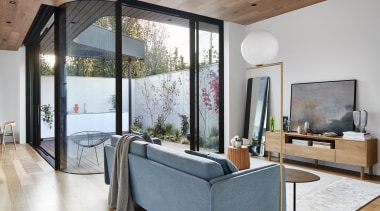Timber floor and ceiling bookend the white interior. 