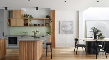The vertical symmetrical shiplap-clad forms hide an existing 