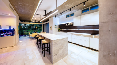​​​​​​​This marble island has a waterfall countertop with countertop, floor, flooring, interior design, kitchen, real estate, gray