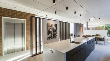 ​​​​​​​This minimalist kitchen has recessed cabinet handles while architecture, countertop, house, interior design, kitchen, real estate, gray