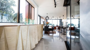 ​​​​​​​A run of sculptural plywood storage cabinetry provides architecture, house, interior design, home, plywood, storeage, open plan living, concrete floors, Boon Team Architects