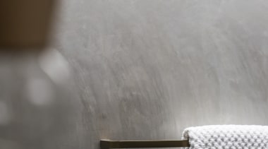 ​​​​​​​Burnished brass accessories bring a rich accent to floor, wall, grey tiles,  Arc Seven, towel rail, brass