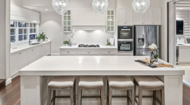 ​​​​​​​Given the level of detailing used in the architecture, bar stool, cabinetry, countertop, cupboard, timber flooring, furniture, hardwood, interior design, kitchen, light fixture, lighting, stool, white, wood flooring, Baahouse + Baahouse Architecture, Ceasarstone