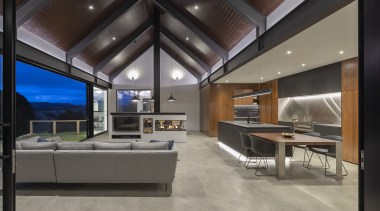 ​​​​​​​A lowered ceiling helps define this kitchen in apartment, architecture, building, ceiling, daylighting, design, floor, flooring, furniture, glass, home, house, interior design, lighting, living room, loft, office, property, real estate, room, table, wall, window, gray, black