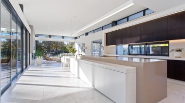 ​​​​​​​The long living zone in this home includes architecture, design, floor, flooring, home, house, interior design, kitchen, living zone, Clerestory windows, O'Neil Architecture