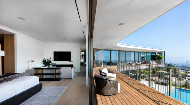 ​​​​​​​At one end of the first floor of architecture, balcony, building, wood floor, floor, flooring, deck, bedroom, furniture, home, house, interior design, living room, table, QPC