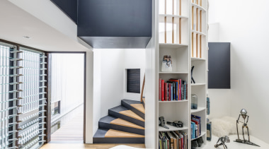 ​​​​​​​The spiral staircase in this family home by home, house, bookcase, design, floor, flooring, furniture, home, house, interior design, living room, shelf, shelving, space, stairs, CplusC Architectural Workshop