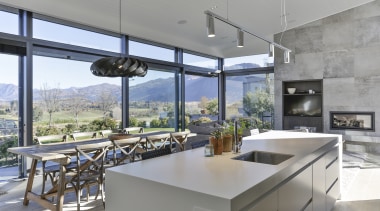 ​​​​​​​This home makes the absolute most of its apartment, architecture, building, countertop, floor, flooring, furniture, picture windows, home, house, interior design, kitchen, lresidential area, Koia Architects