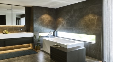 ​​​​​​​White solid surface and low-set windows lift the architecture, bathroom, bathtub, building, cabinetry, ceiling, countertop, design, floor, flooring, furniture, home, house, interior design, lighting, material property, plumbing fixture, property, room, sink, tap, tile, wall, black, gray