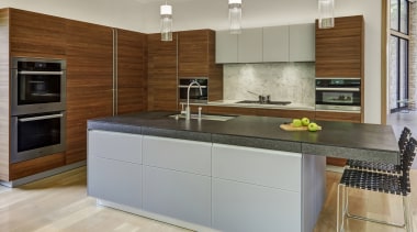 ​​​​​​​Soft, natural materials were selected for this kitchen building, cabinetry, ceiling, countertop, cuisine classique, cupboard, floor, flooring, furniture, home, home appliance, house, interior design, kitchen, kitchen appliance, kitchen stove, major appliance, material property, property, real estate, room, tile, gray, brown