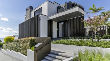 ​​​​​​​To downplay this home’s presence to the street, gray
