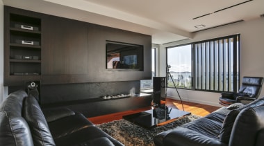 ​​​​​​​Dark living room cabinetry anchors the white, open gray, black
