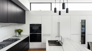 ​​​​​​​A side bank of tall white cabinetry contains white