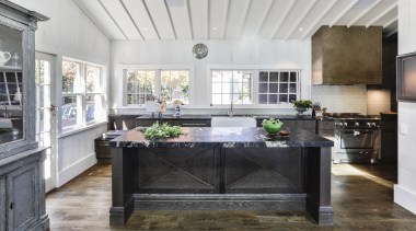 Elegant chocolate-stained oak cabinetry panelling and chunky leathered gray, white